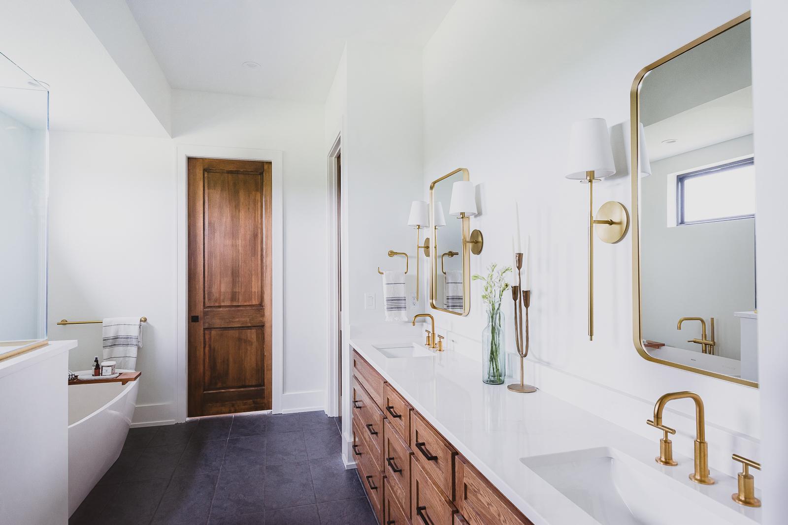 Double sink primary bath and freestanding tub in the Haven custom home project.