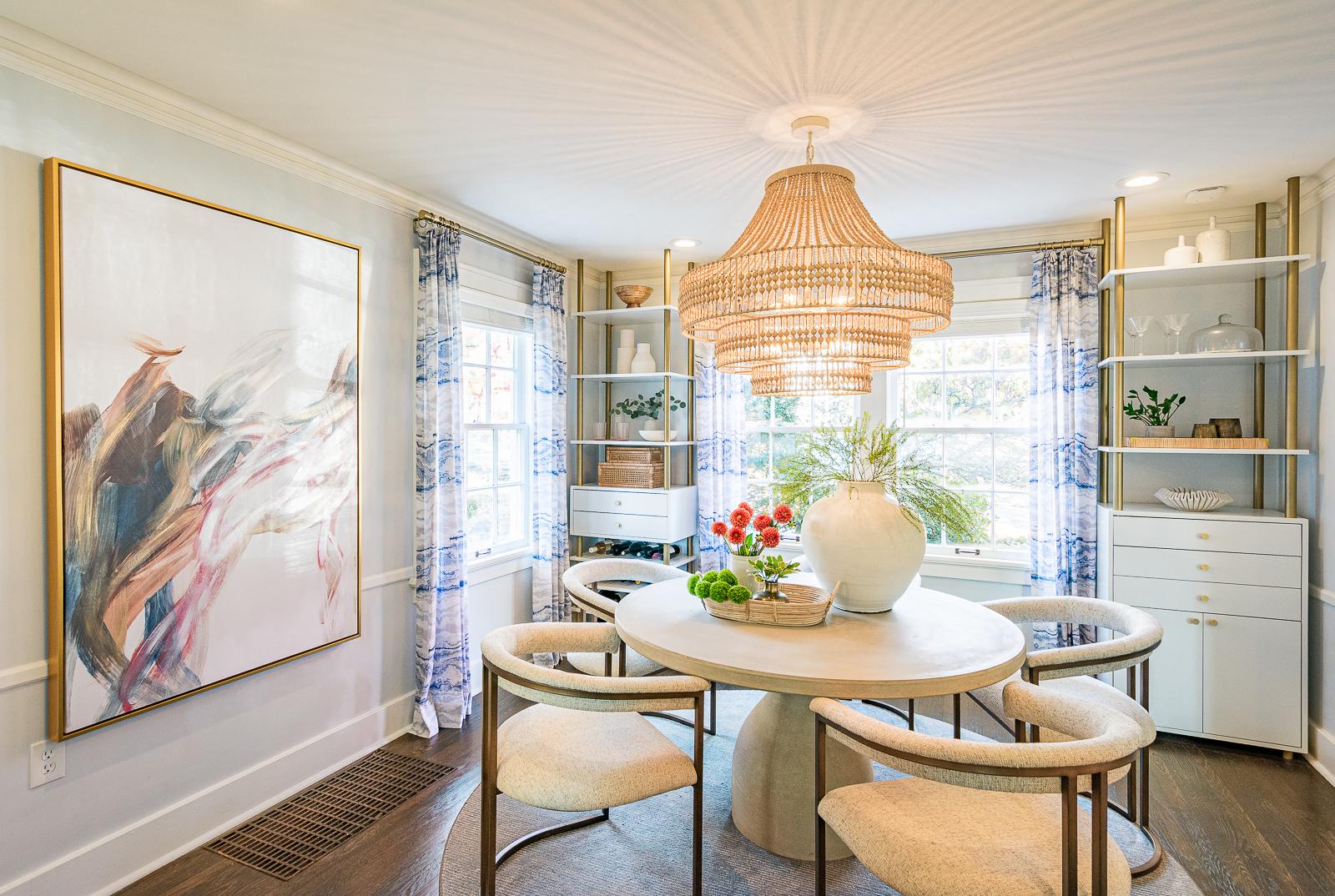 Wide angle shot of the dining room in this historic home renovation project by Sara Svehla Interior Design. Featuring custom drapery and built-in cabinets framing the front window of the dining room. 