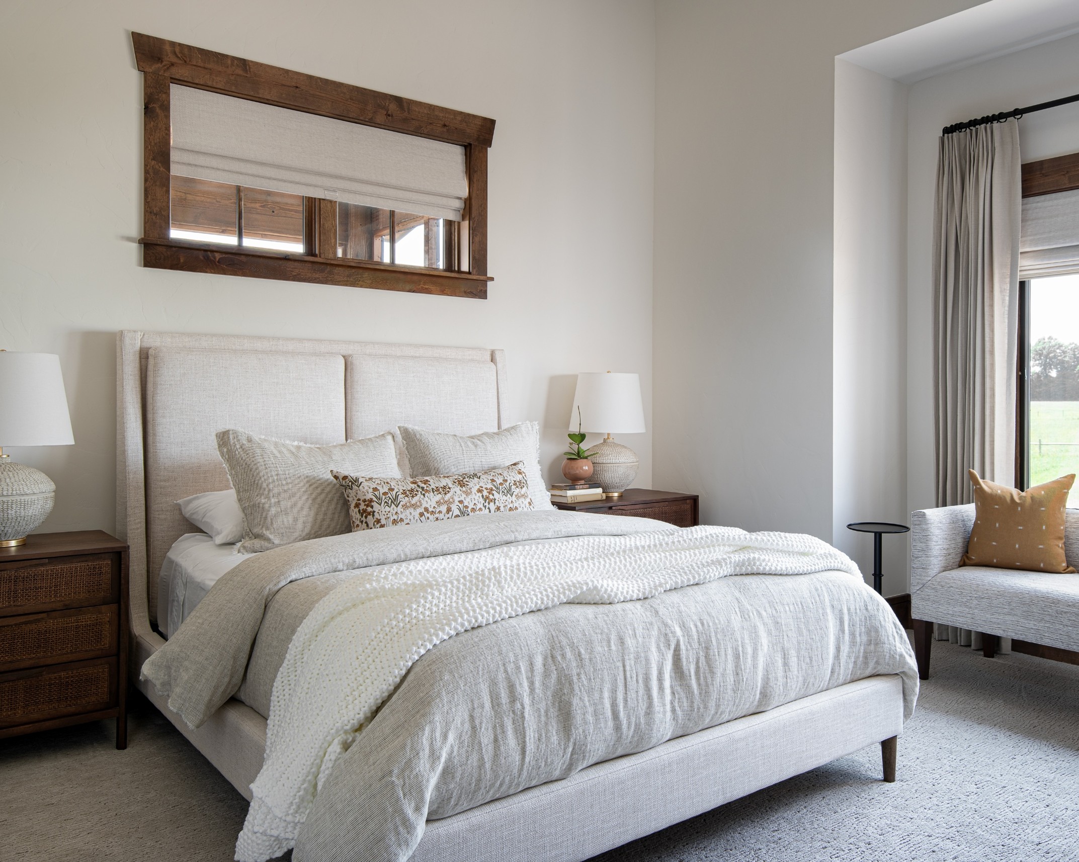 Artisan Home - Refined rustic guest room featuring an upholstered queen bed, matching nightstands, custom window treatments and linen, neutral colored bedding.