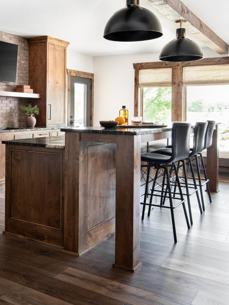Artisan home lower level wet bar showcasing a brushed titanium granite countertop, custom cabinetry and 8' ceilings.